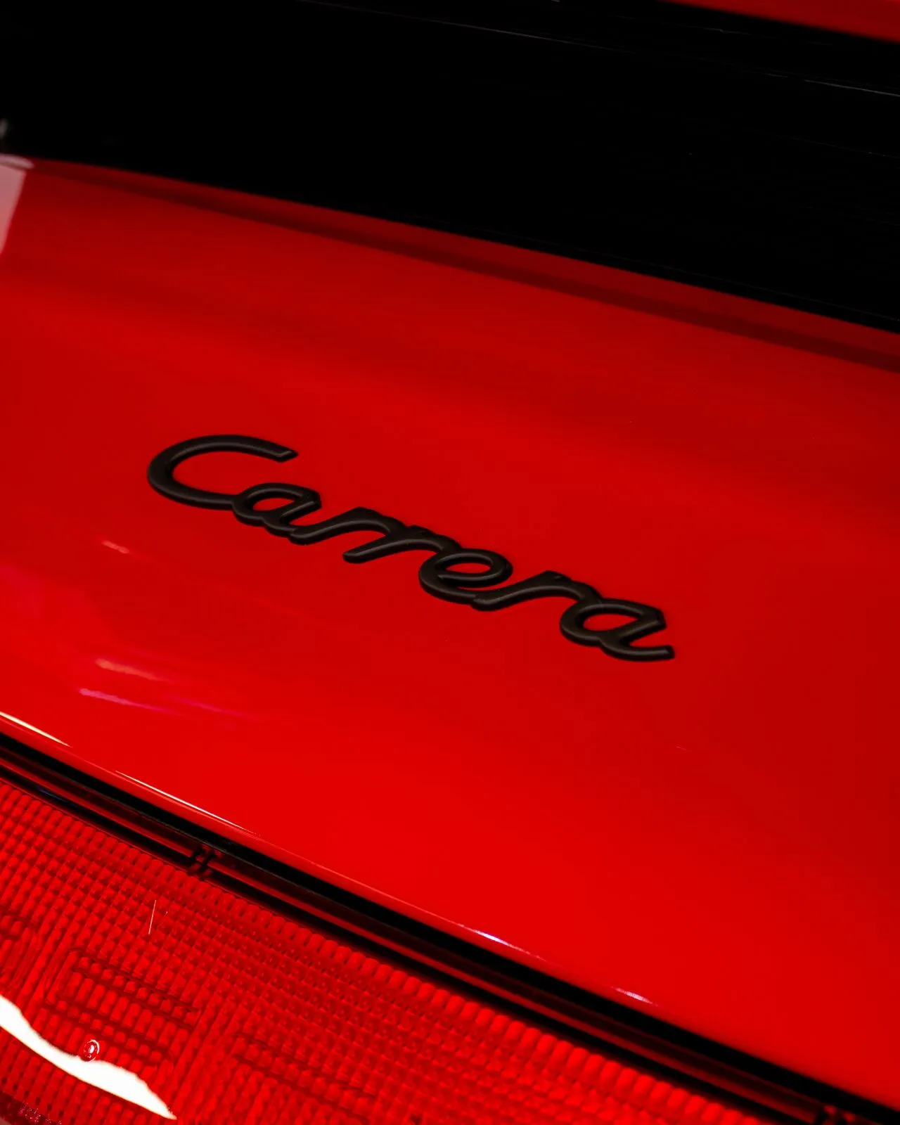 Porsche Carrera badge on ceramic coated red paint
