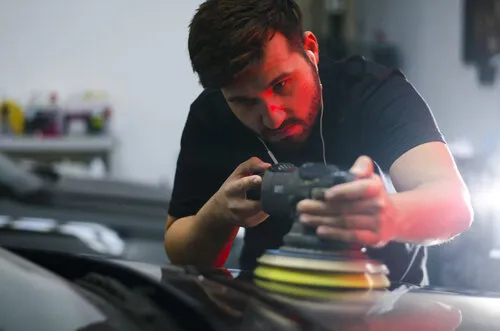 Detailer performing paint correction