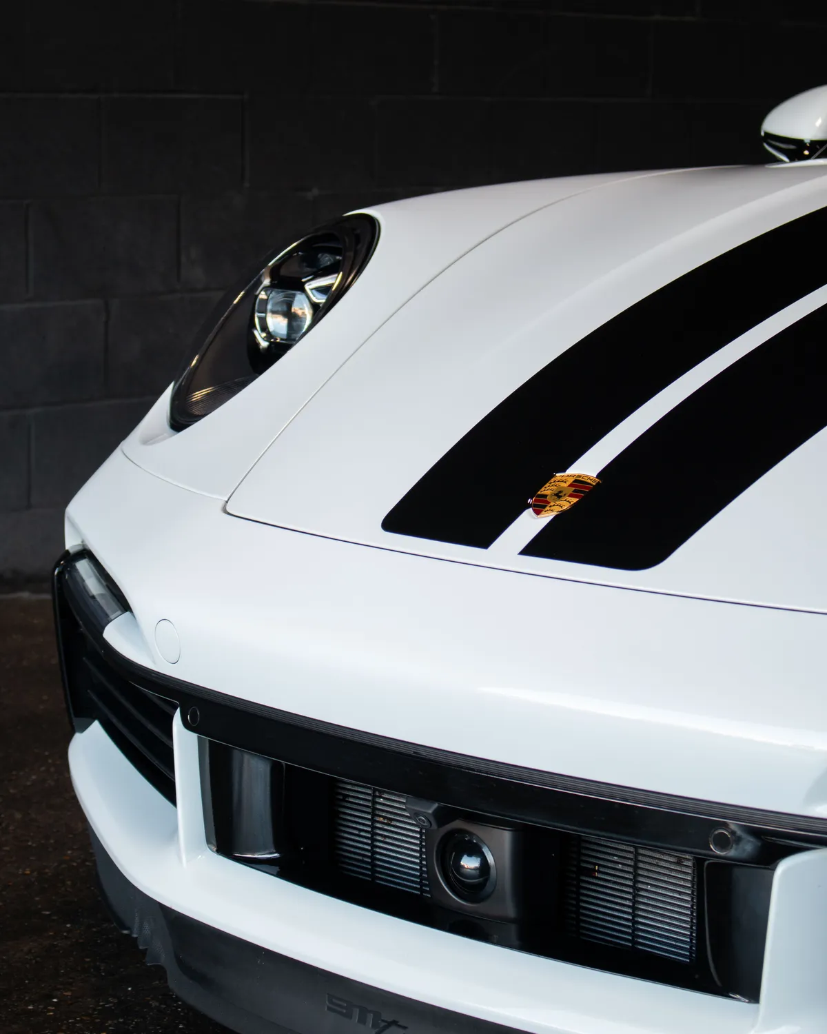 White Porsche 911 with racing stripes - PPF protected