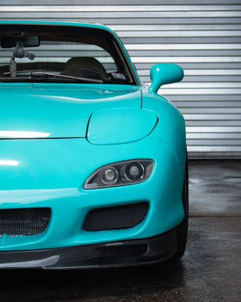Teal vinyl wrapped RX-7 front quarter close-up
