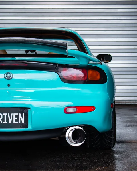 Teal wrapped Mazda RX-7 rear with DRIVEN plate